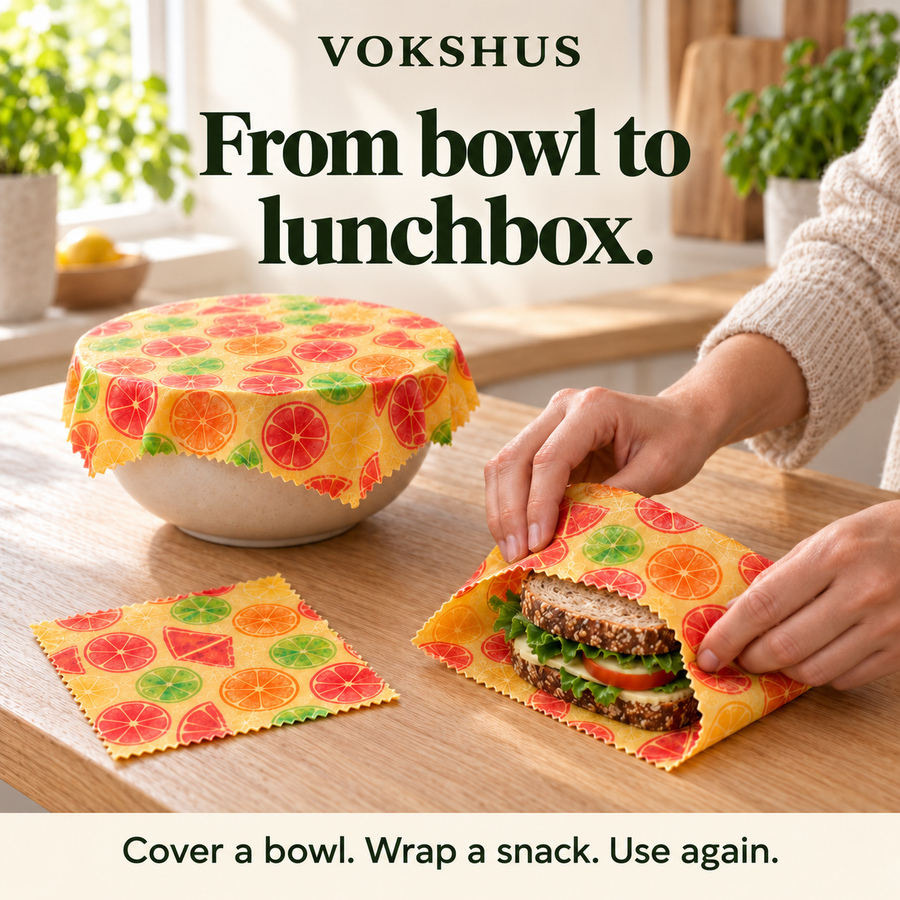 Two lunch boxes with lids and grey bands beside three Sitrus wraps.